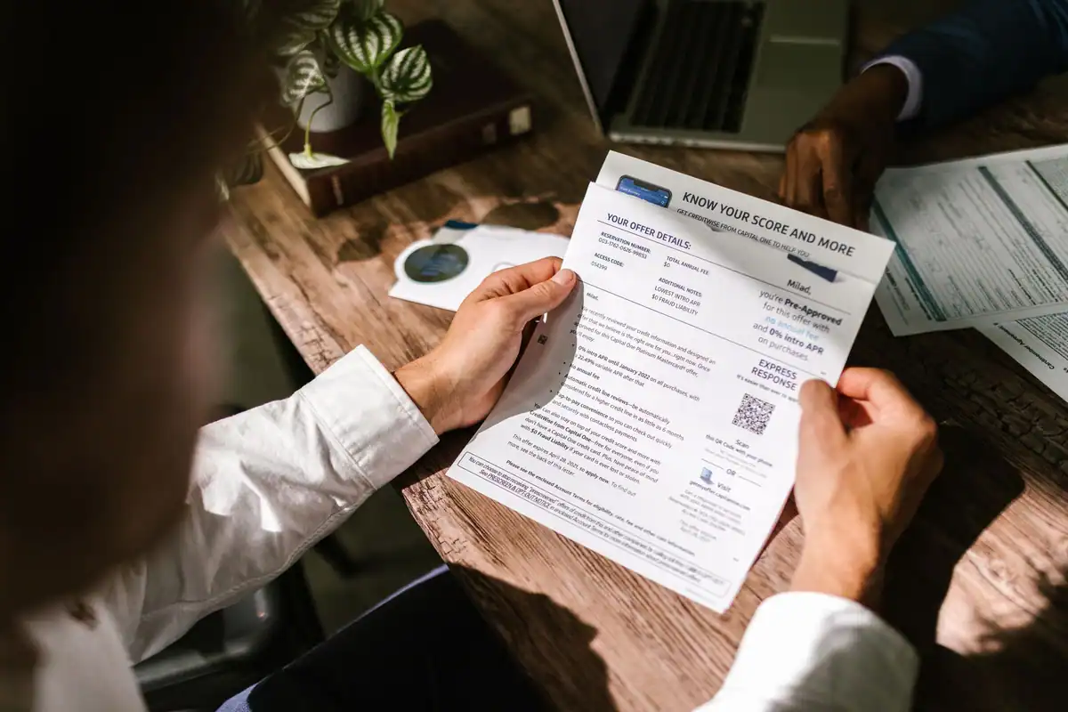 Bărbat care citește atent un document financiar la birou